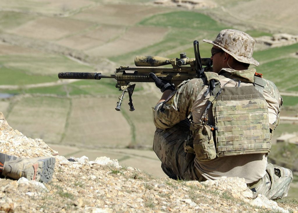 A_coalition_Special_Operations_Forces_member_fires_his_sniper_rifle_from_a_hilltop_during_a_firefight_near_Nawa_Garay_village_(120403-N-MY805-202)